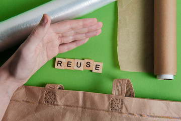 reduce, reuse and recycle word in vintage wooden letterpress type blocks, flatlay on green font