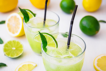 Citrus cold lemonade with lime, mint and lemons in glasses