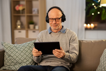 technology, old people and lifestyle concept - happy senior man with tablet pc computer and...