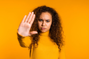 No, never, pretty curly woman disliking and rejecting gesture by stop palm sign. Portrait of young...