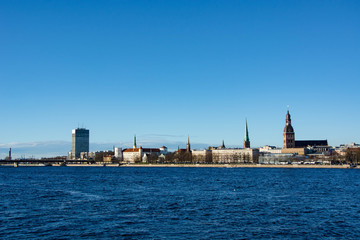 Fototapeta premium Sunny day at Riga, Latvia. Panorama of the city. Daugava river. Dome cathedral.