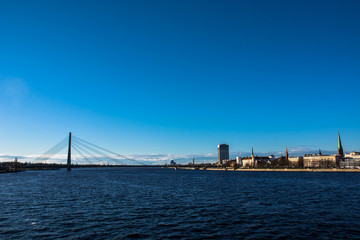 Sunny day at Riga, Latvia. Panorama of the city. Th bridge over the Daugava river.