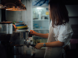Asian woman with coffee in cafe