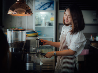 Asian woman with coffee in cafe
