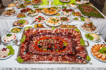 Catering buffet table with cold snacks. Delicious appetizers on the table, self serve.