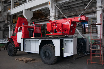 Plant for the production of fire engines. Making a fire truck. Machine without equipment. Red fire engine top view in profile