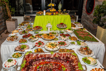 Catering buffet table with cold snacks. Delicious appetizers on the table, self serve.