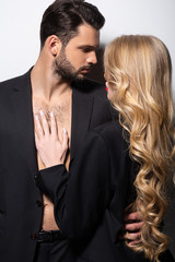 handsome bearded man hugging beautiful woman on white