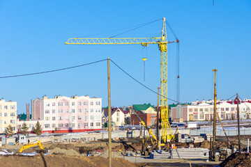 organization of a construction site in the spring, the start of construction, digging a foundation pit and driving piles