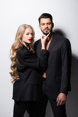 beautiful young woman touching face of bearded boyfriend on white