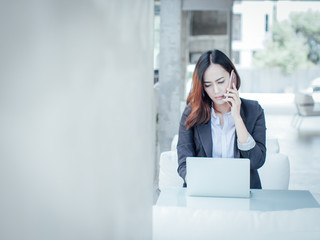 Asian business woman with laptop happy and smile concept success work