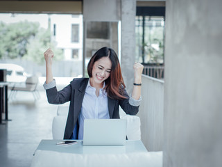 Fototapeta premium Asian business woman with laptop happy and smile concept success work