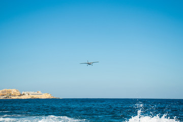 Fototapeta na wymiar Small aiplane above the sea