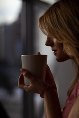 girl in pink dress holding coffee mug close up