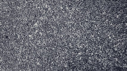 Small pieces of rock embedded in cement floor. Deigned for dark black background.