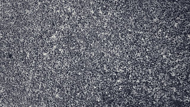 Small pieces of rock embedded in cement floor. Deigned for dark black background.