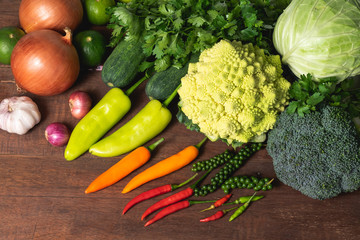 Various kinds of fresh vegetable on rustic wood background with copy space for text