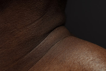 Neck. Detailed texture of human skin. Close up shot of young african-american male body. Skincare, bodycare, healthcare, hygiene and medicine concept. Looks beauty and well-kept. Dermatology.