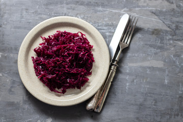 salad purple cabbage on dish on ceramic background