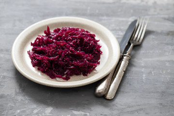salad purple cabbage on dish on ceramic background