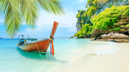 Obraz na płótnie Canvas Longtale boat on the white beach at Phuket, Thailand. Phuket is a popular destination famous for its beaches.
