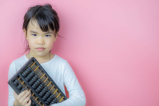 Asian Chinese little girl with abcus chinese calculator