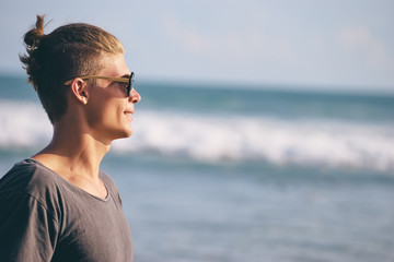 Portrait of young handsome man on the sea shore.