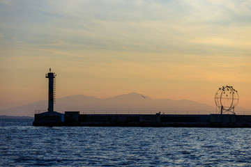 Fototapeta premium lighthouse at sea at sunset