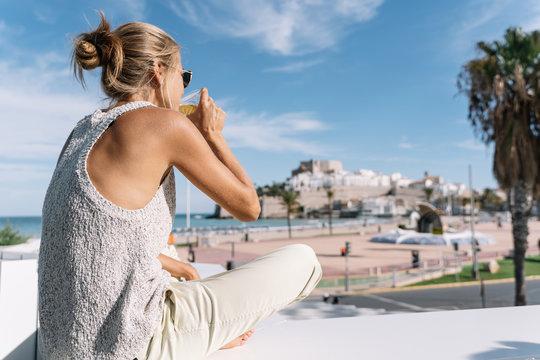 girl looking at peniscola city, in spain with copyspace