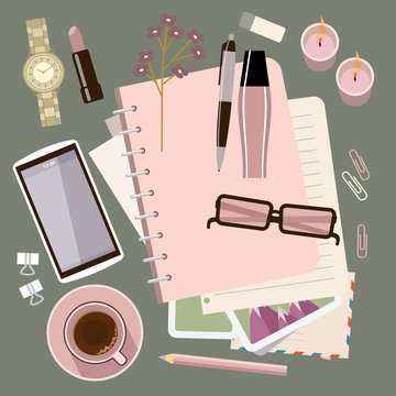 Personal diary on the table. Women's glamorous things. Clock, lipstick, stationery, candles, smartphone. Stylish workplace.