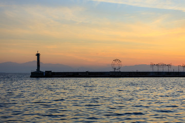 lighthouse at sea at sunset