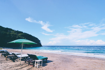 Vacation concept. Sun loungers and umbrella on sand sea beach.