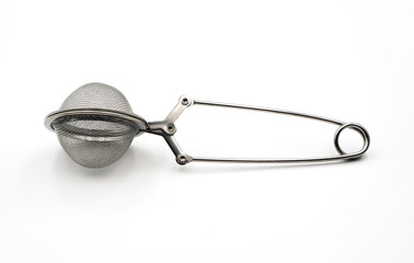 tea strainer or tea infuser in metal ball shape made from stainless steel isolated on white...