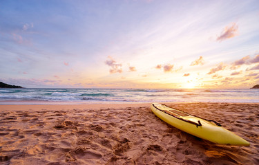 Beautiful landscape. Sunset on the sea beach with lifeguard surf board on sand.