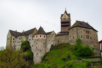 Fototapeta na wymiar Facade of Loket Castle, a 12th-century gothic castle on Karlovarsky kraj, a rock on a hill, in Czech Republic