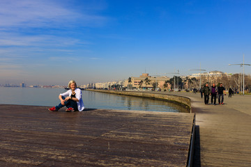 girl on the promenade in a white shirt