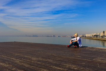 girl on the promenade in a white shirt