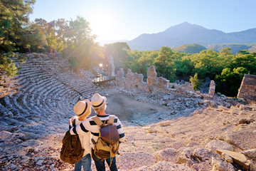 Travel and tourism. Senior family couple enjoying view together on ancient amphitheatre.