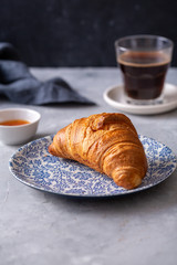 Breakfast with croissant and black coffee