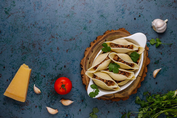 Italian pasta Conchiglioni Rigati stuffed with meat.