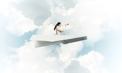 Elegant woman playing trumpet brass