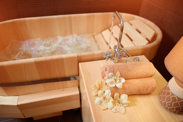 Fototapeta na wymiar Relaxing cedar wood bath with hydro massage