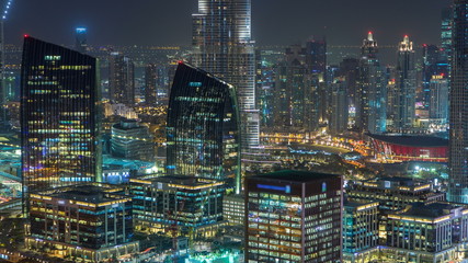 Aerial view of Dubai downtown Lake area night timelapse and skyscrapers of Old Town Island, from top. Skyline urban city of Dubai.
