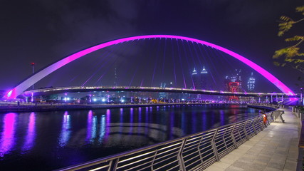 Pedestrian Bridge over the Dubai Water Canal night timelapse, United Arab Emirates