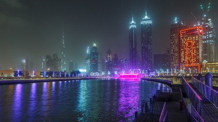 Illuminated Waterfall at the Sheikh Zayed Bridge timelapse, part of the Dubai Water Canal. Dubai, United Arab Emirates, Middle East