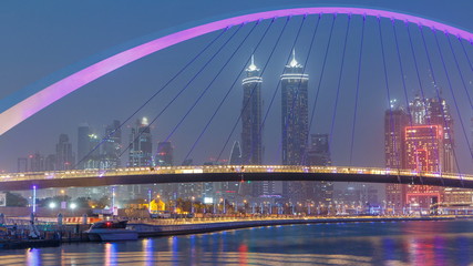 Fototapeta na wymiar Pedestrian Bridge over the Dubai Water Canal day to night timelapse, United Arab Emirates