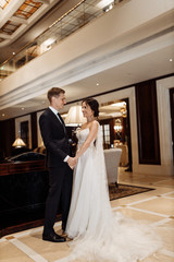 Fototapeta premium Happy and elegant couple on the hotel hall