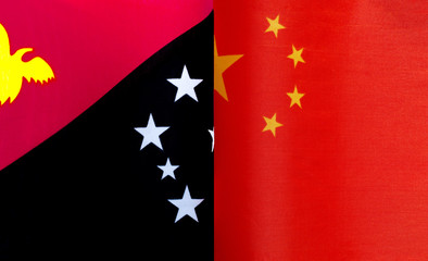 fragments of national flags of Papua New Guinea and China close up