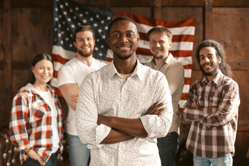 Fototapeta na wymiar Diverse American Patriotic Team Standing On Of American's Flag Back