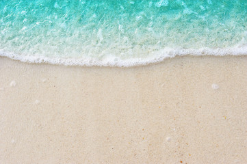 Fototapeta na wymiar Turquoise Soft ocean blue wave on Fine sandy beach Background